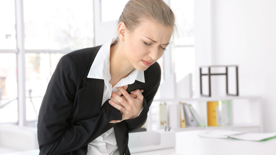 Heart failure - woman suffers chest pain